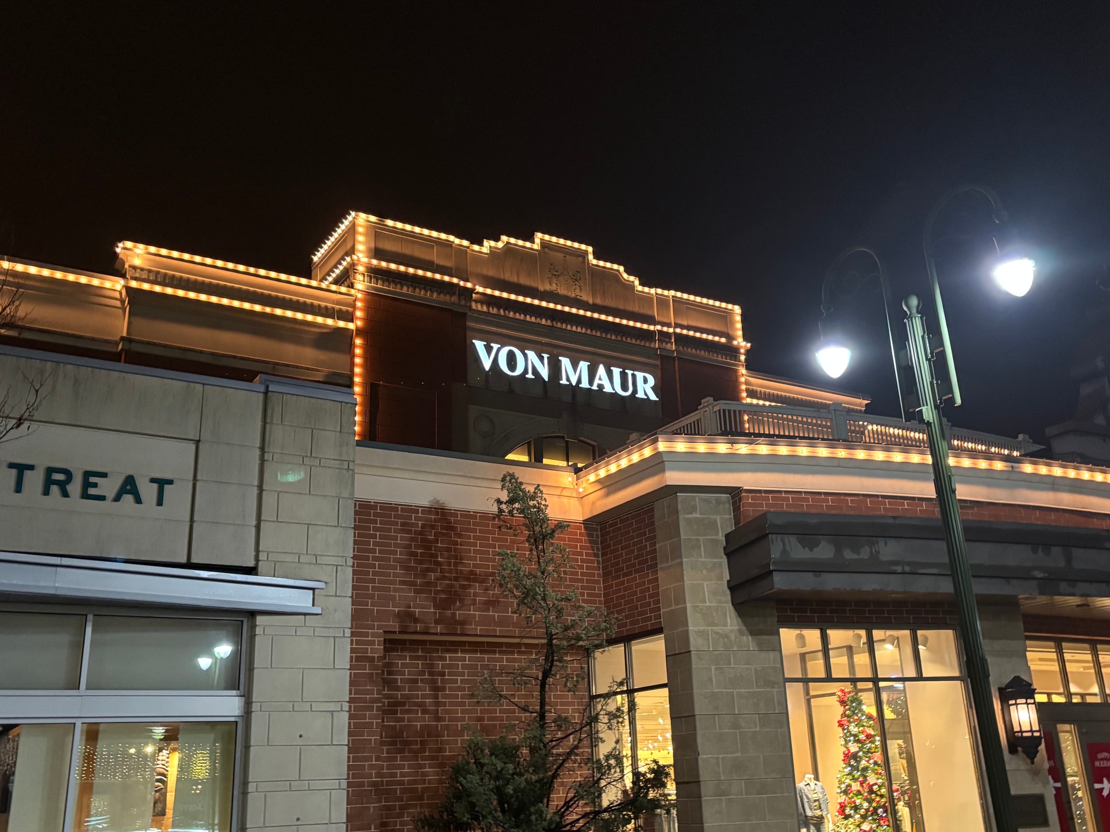 Von Maur retail facade traced with warm-white holiday lights